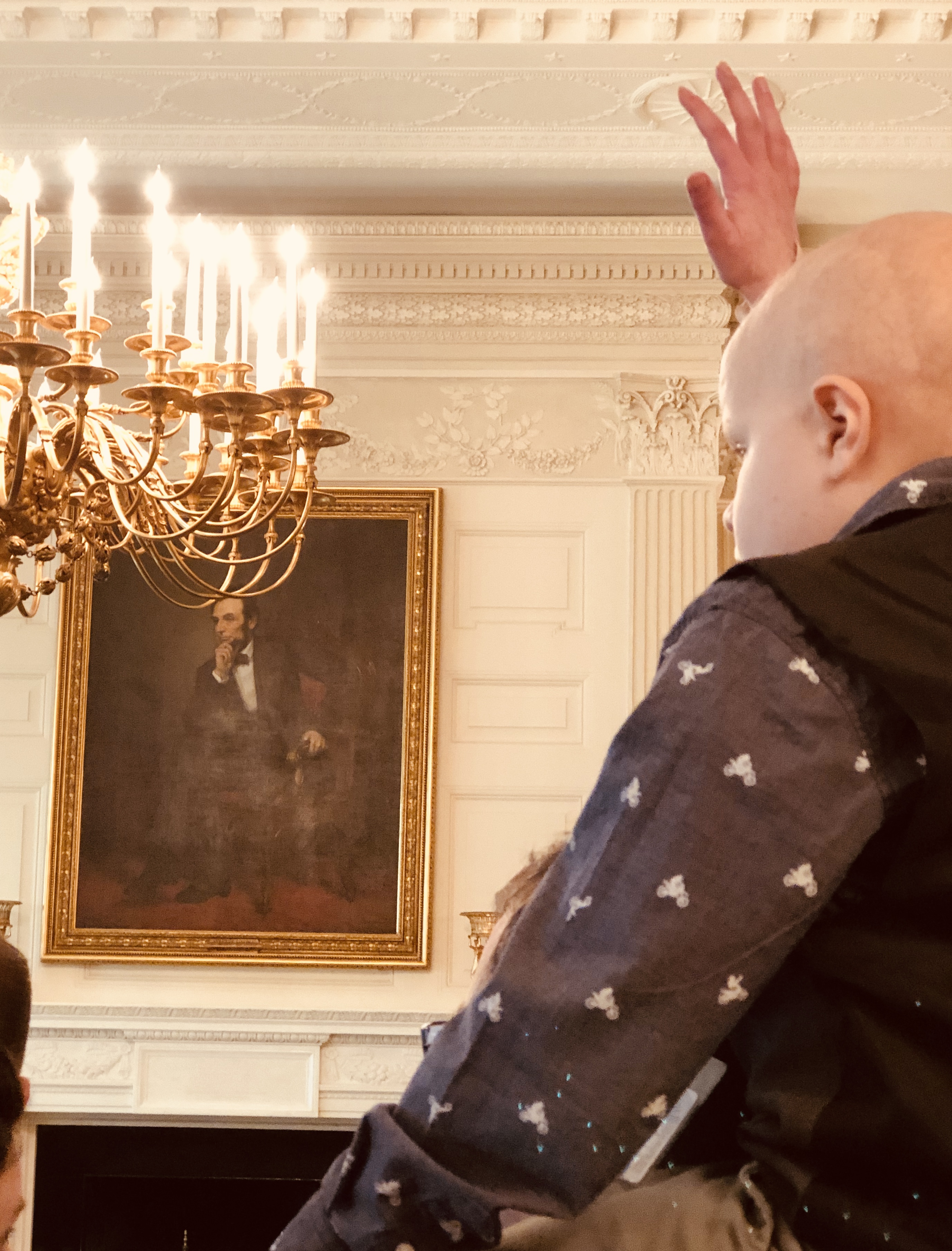 Answering a question in the formal dining room under the watchful gaze of Lincoln