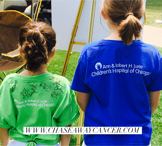 Darcy and Harlow (Lurie patient and cancer survivor) show off their many autographs while representing the hospital